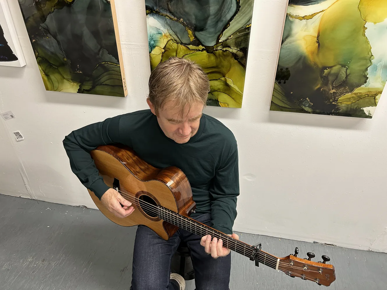 Simon Fox playing an acoustic guitar