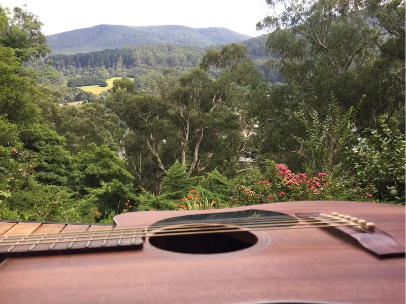 Sunny deck outside of Melbourne with a guitar